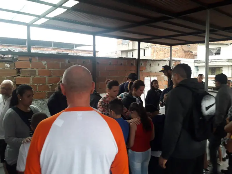 People standing close together under the roof of a terrace