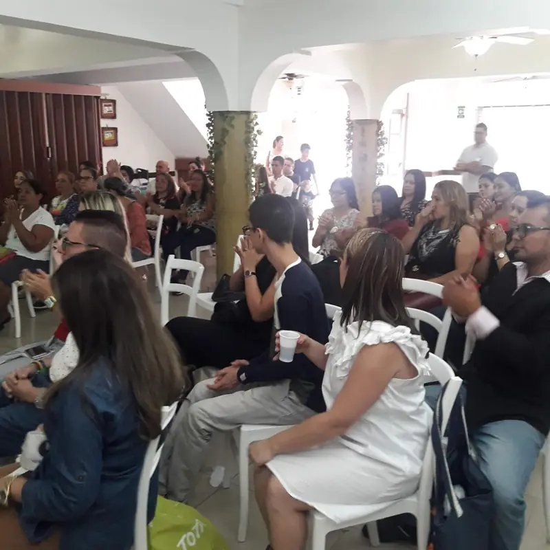 Couples and families seated, listening to a talk