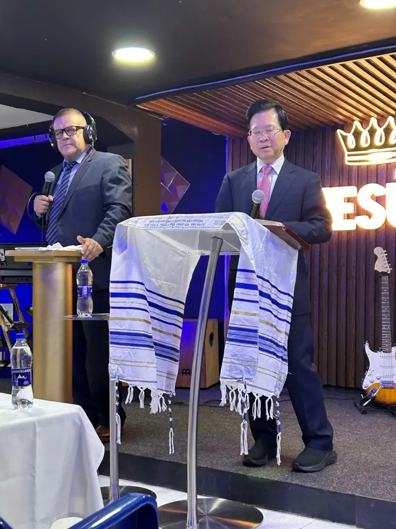 Two preachers with microphones on a church stage