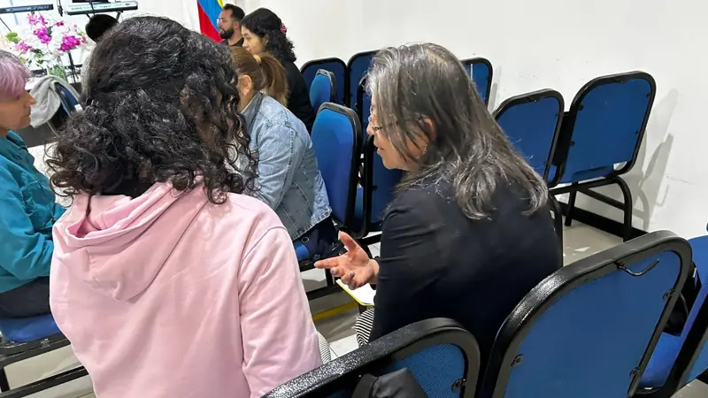 Participants talking in small groups during a training