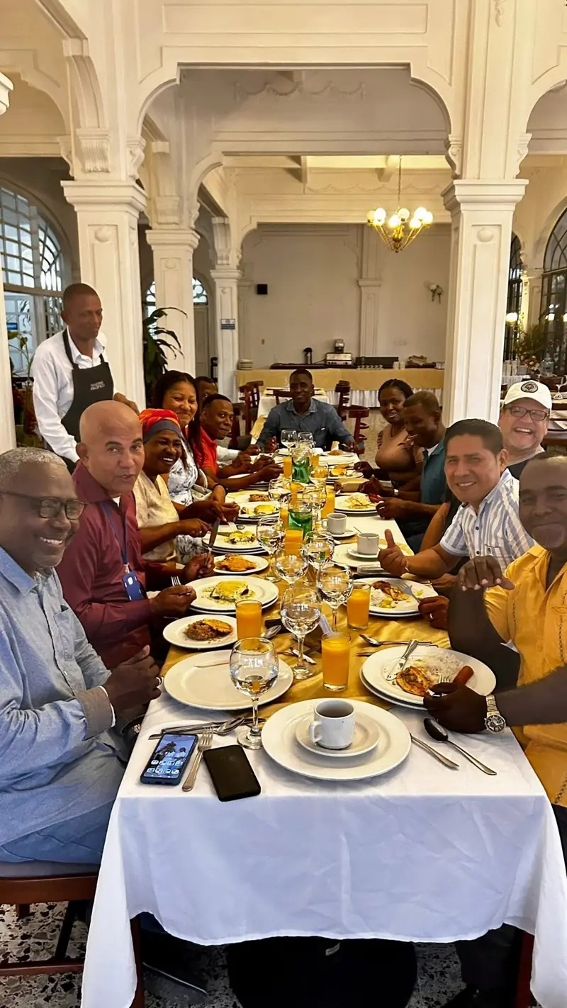 Leaders sharing breakfast at a long table