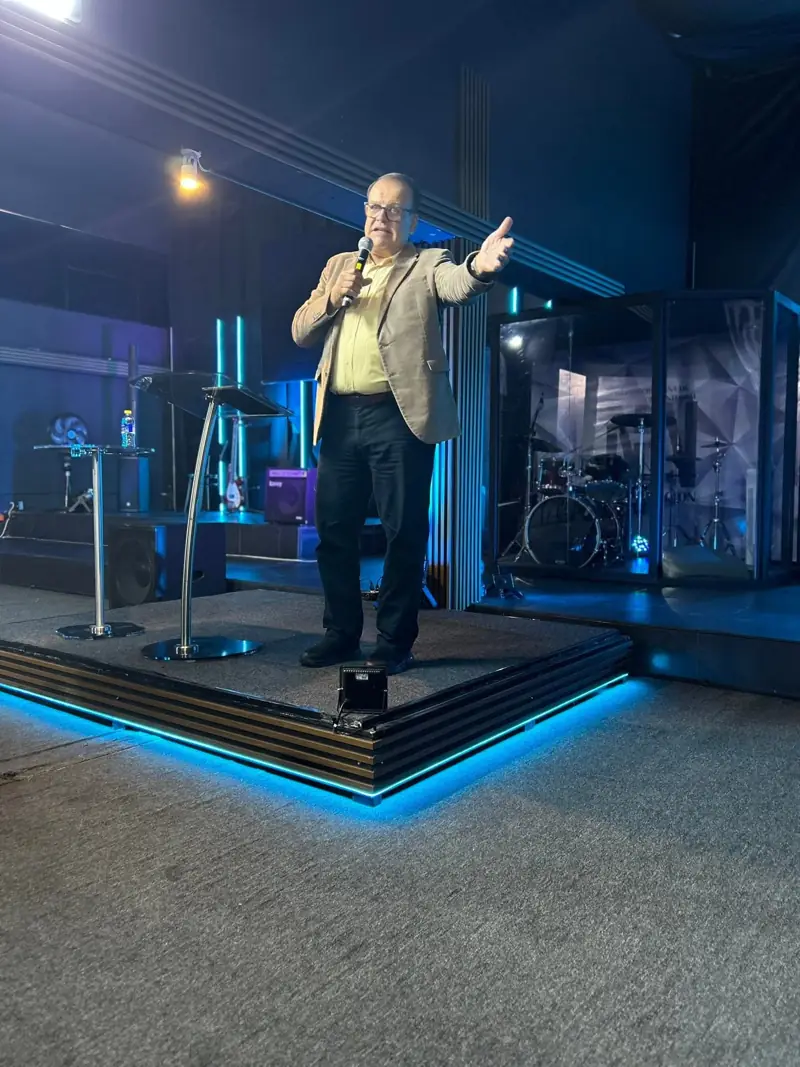 A preacher speaking from a church stage
